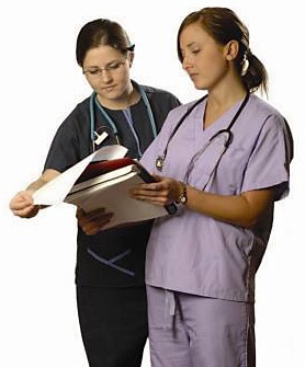 2 nurses with paperwork 2