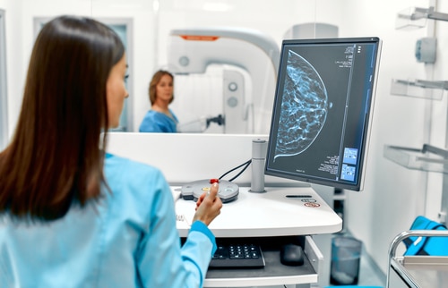 patient undergoes a screening procedure for a mammogram
