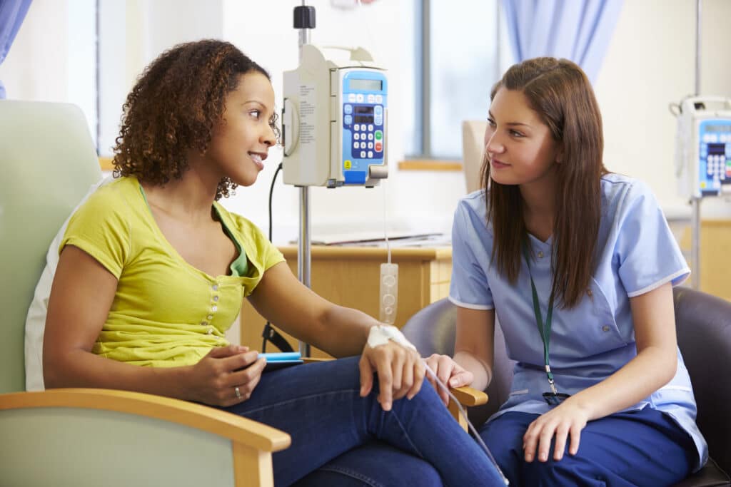 Woman,Undergoing,Chemotherapy,With,Nurse