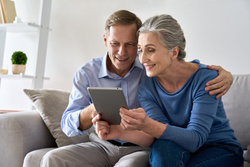 Older woman and young man look at a tablet during telemedicine appointment in Show Low, AZ
