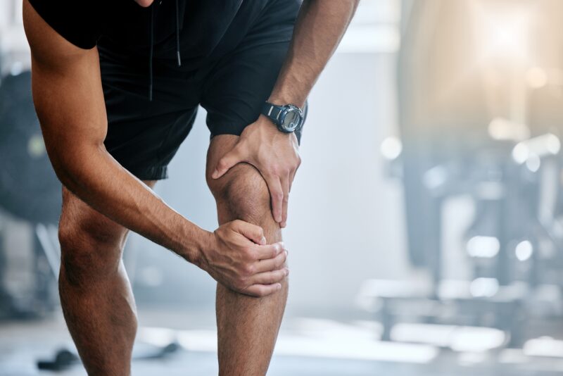 Man holding his knee in pain, needing orthopedic care in Show Low, AZ