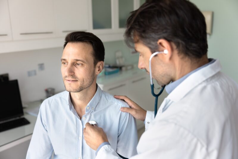 Doctor listening to man's heartbeat in cardiac rehab in Show Low, AZ