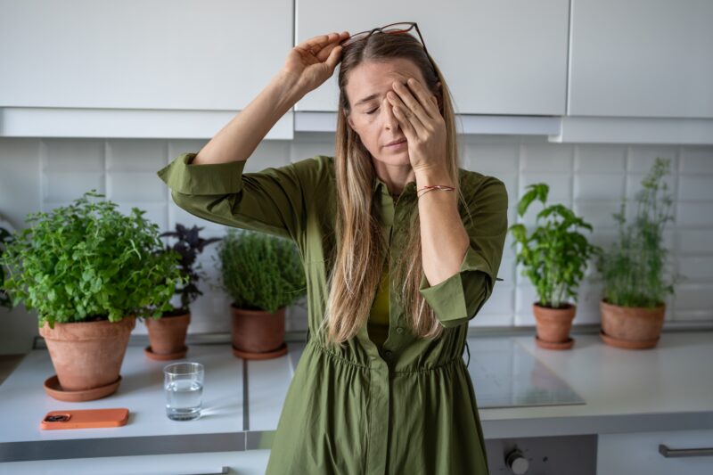 Woman rubbing her eyes from discomfort due to ENT issue in Show Low, AZ