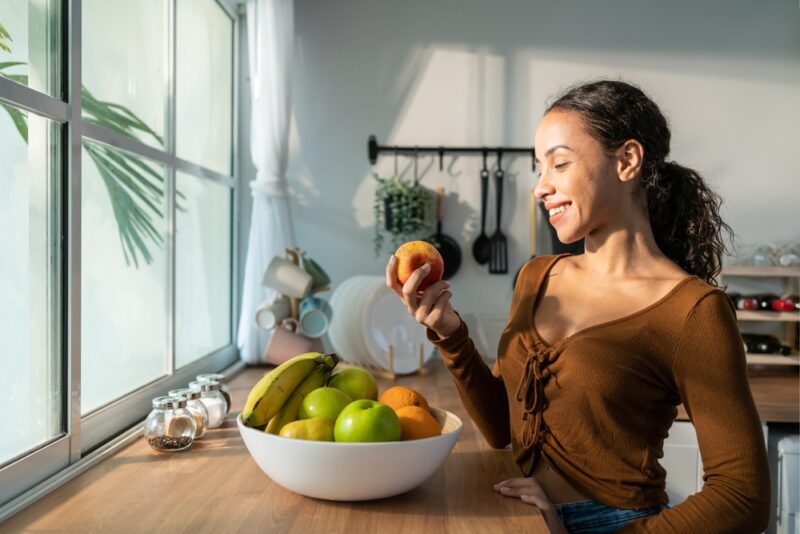 Woman holding an apple after Medical Nutrition Therapy for eating disorders in Show Low, AZ
