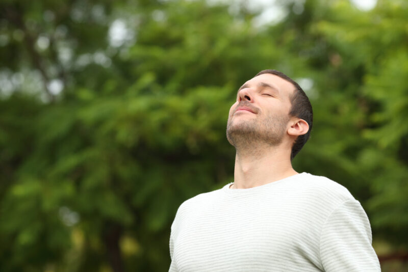 Man with COPD standing outside taking a breath after pulmonary rehab in Show Low, AZ
