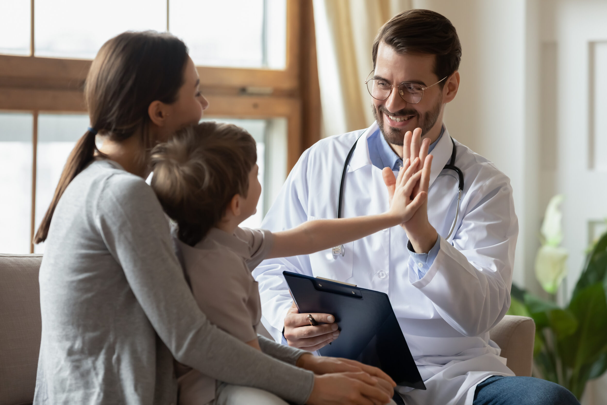 Doctor giving a child a high-five after a family medicine visit in Show Low, AZ